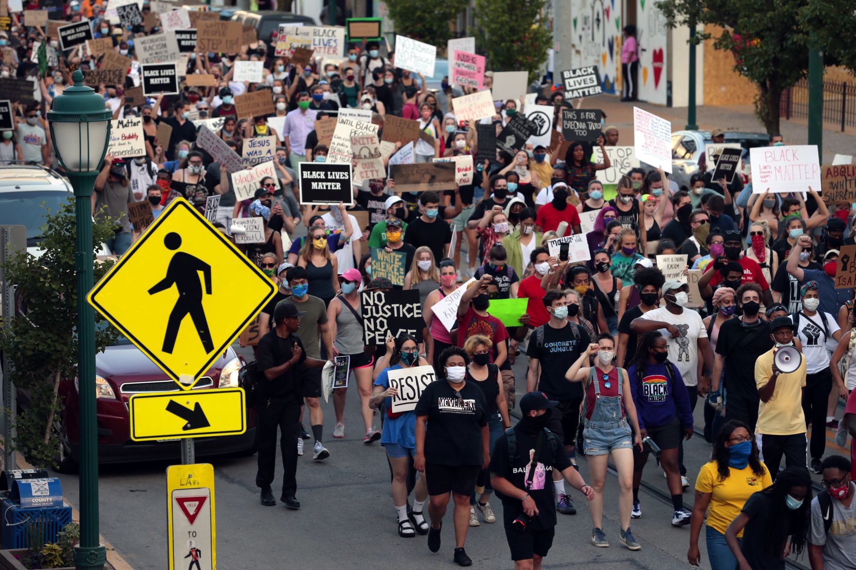 Protesters march through the Delmar Loop
